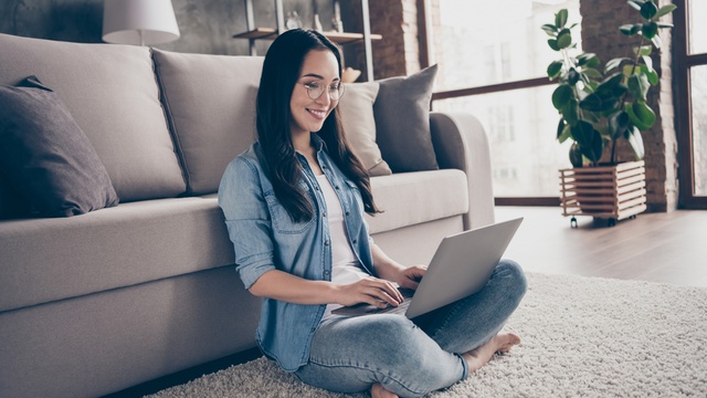woman checking on laptop in lounge