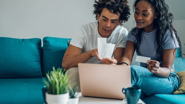 Young couple looking through accounts together