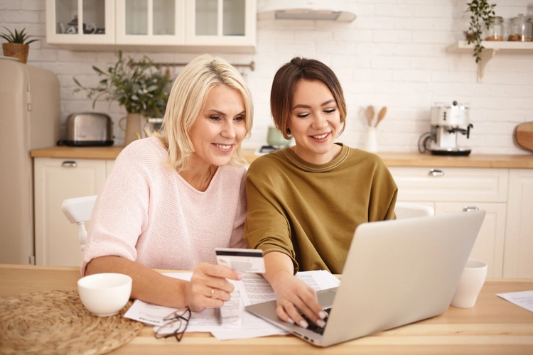 mother and daughter shopping online with credit card
