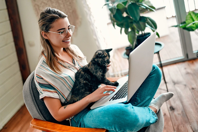 woman on laptop with cat