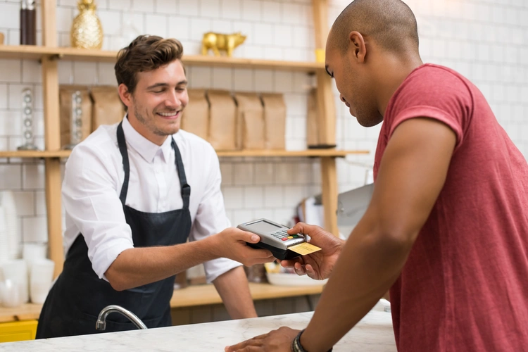 Man paying for something at a shop with a credit card