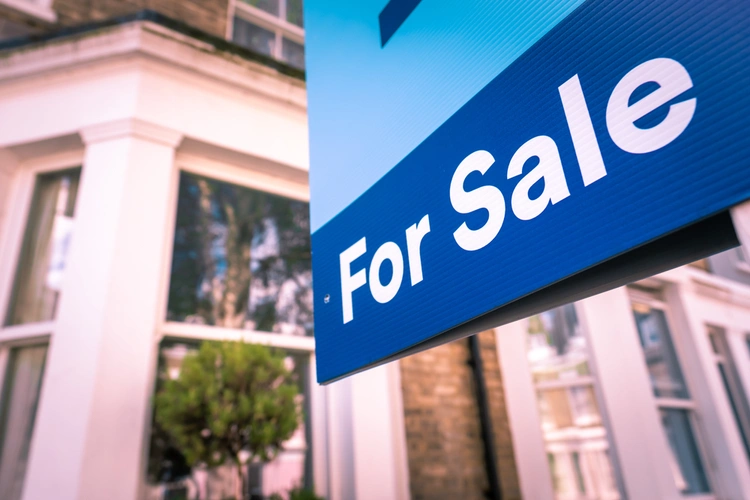 For sale sign in front of a house