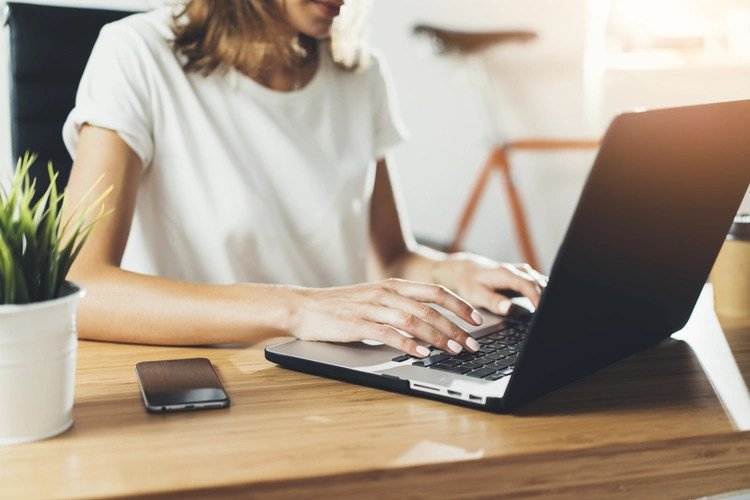 Woman typing on laptop