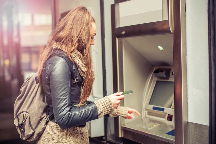 woman withdrawing cash from machine