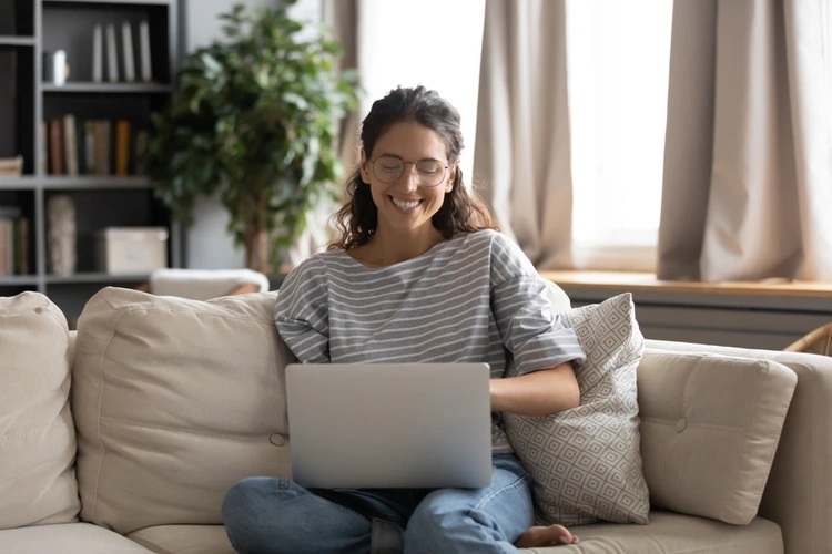 Smiling woman on her laptop