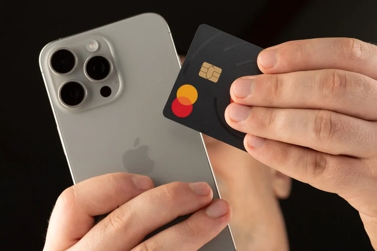 Close up of an Iphone and  Mastercard credit card