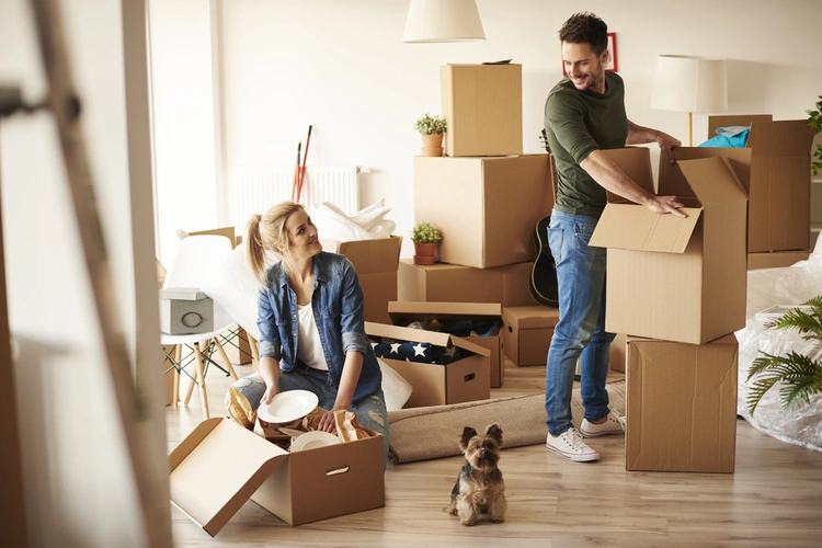 Man and woman packing moving boxes