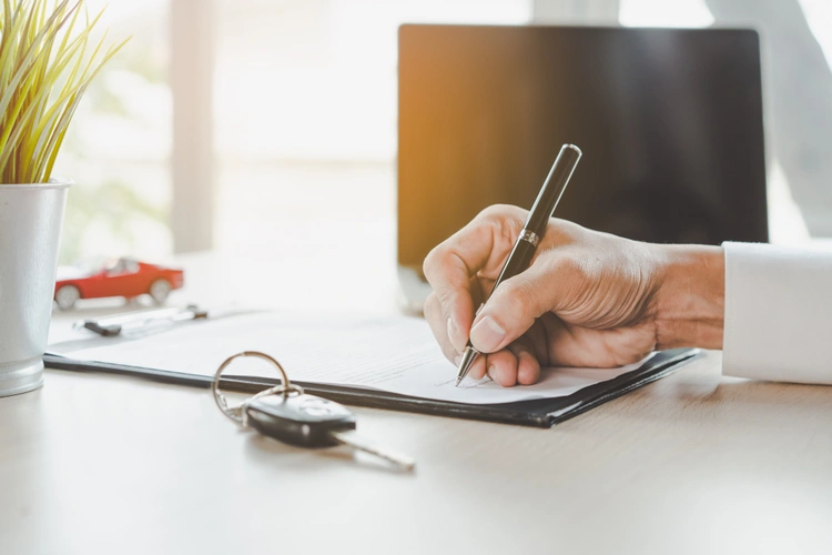 man signing car contract