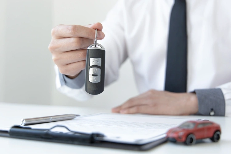 Salesperson holding car key