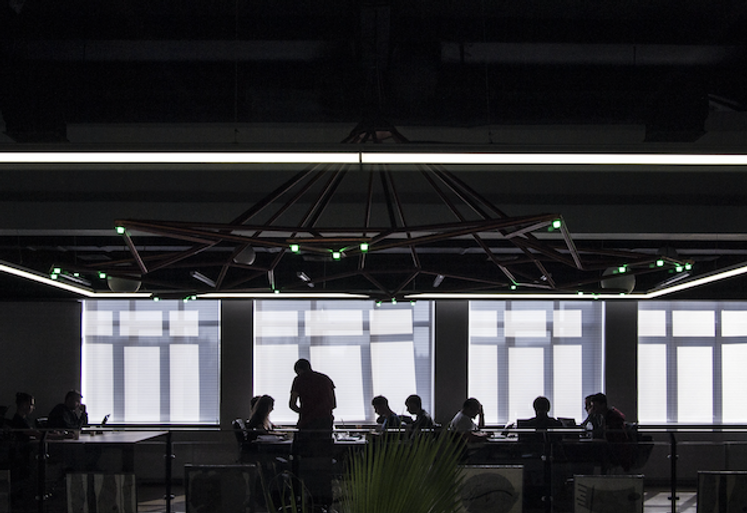 Dark office space with employees