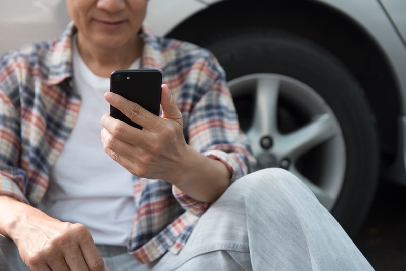 Man on phone outside car