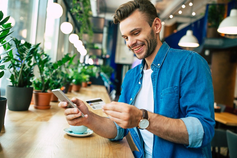 man looking at credit card
