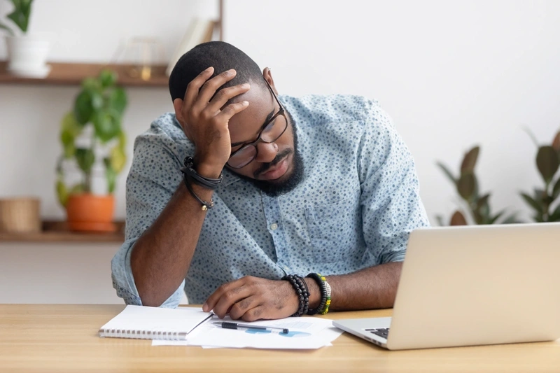 worried looking man on laptop