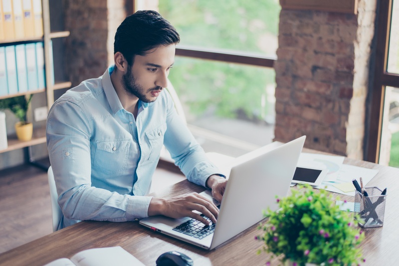 man on laptop searching internet