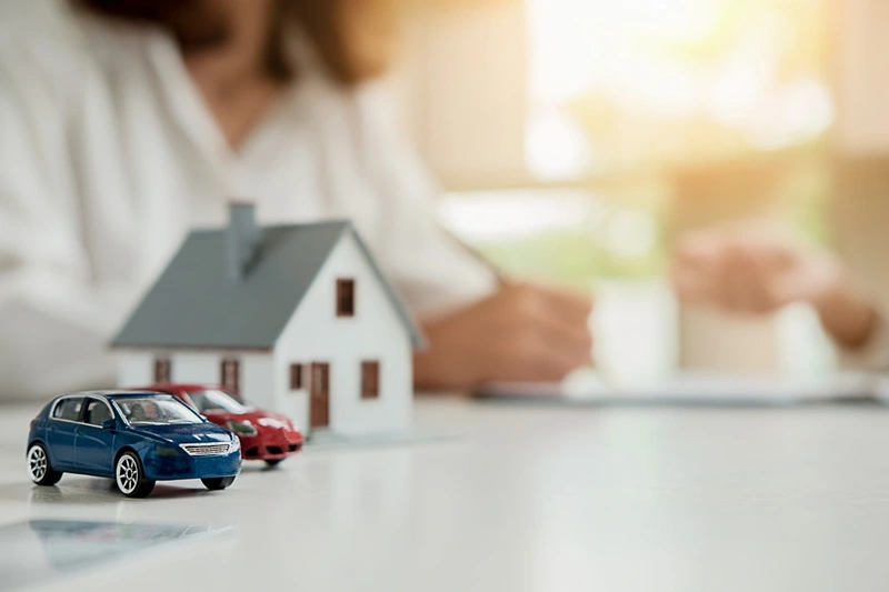 Toy cars alongside a house