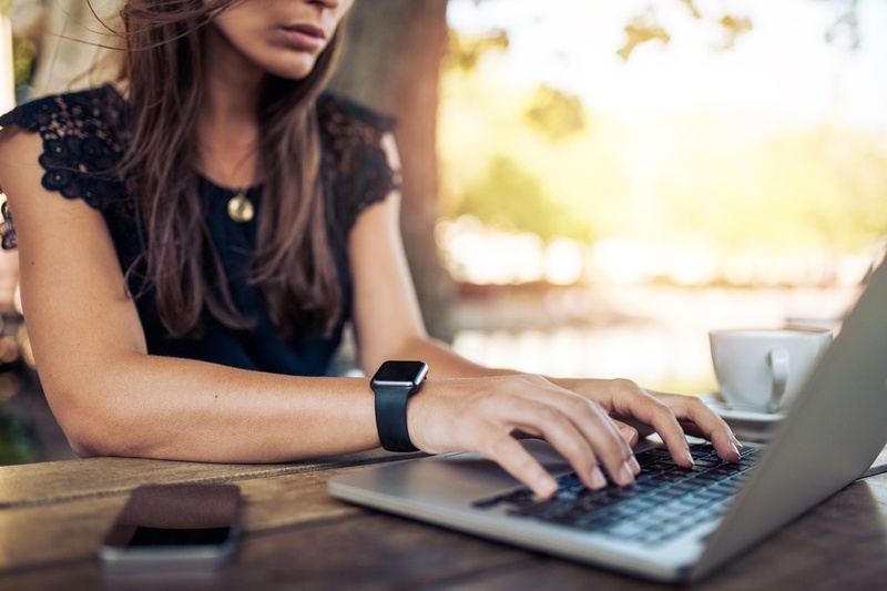 Woman searching on her laptop for a credit card