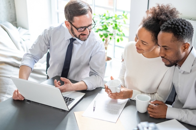 Couple discussing their finances with an advisor