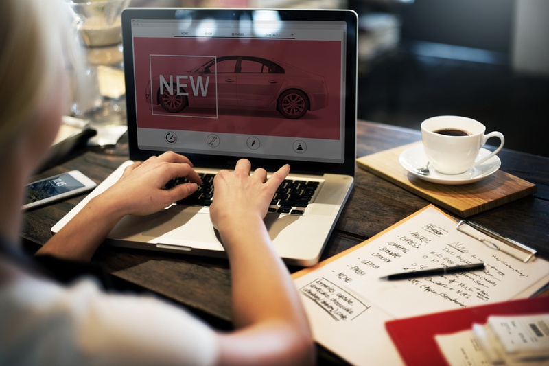 woman on laptop researching new cars