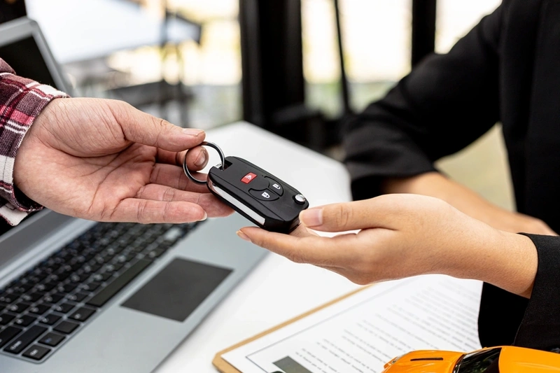 Car keys being passed back to someone