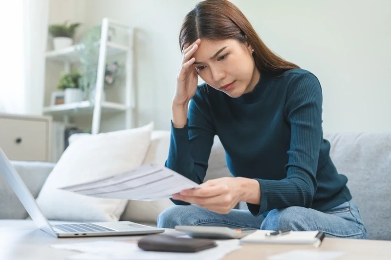 Woman reading her credit card statement