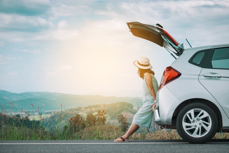 woman leaning on a car