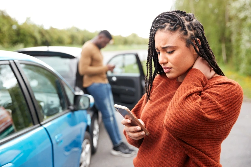 female motorist on mobile after being involved in a road accident