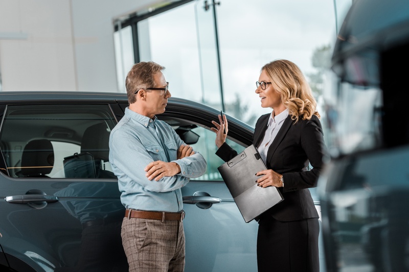 car salesperson talking to a buyer