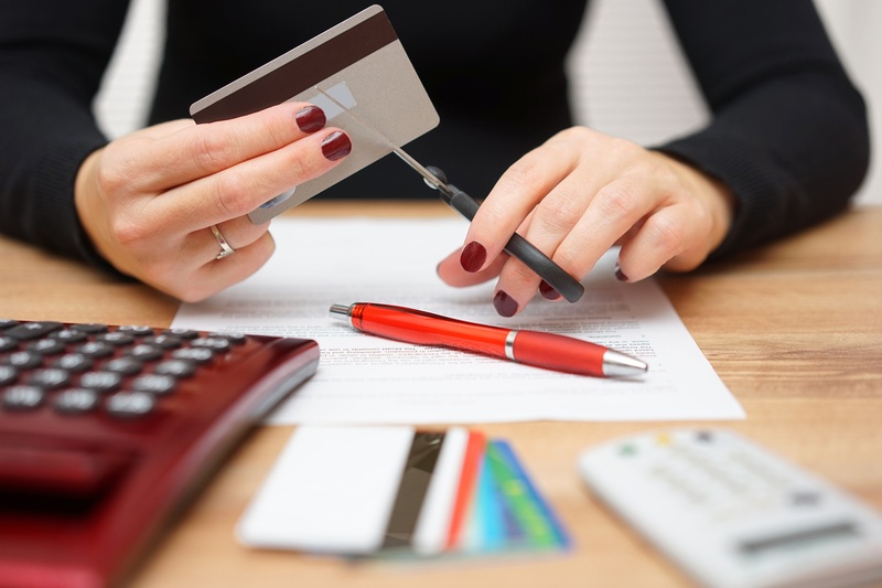 woman cutting credit card