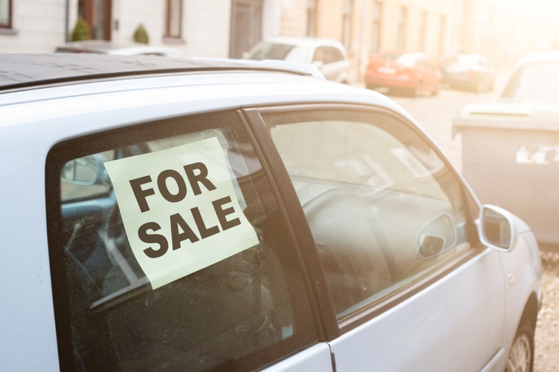 car with for sale sign in the window