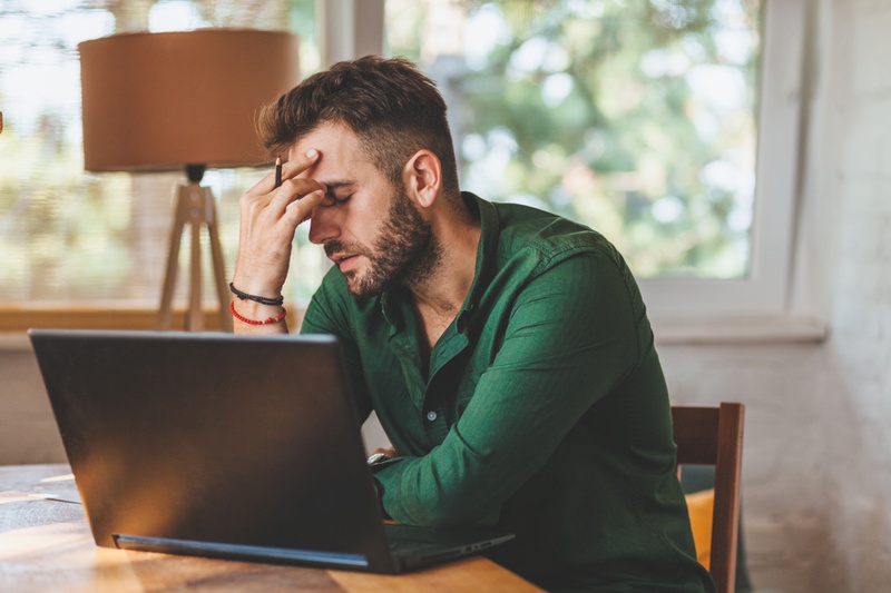 stressed man on laptop
