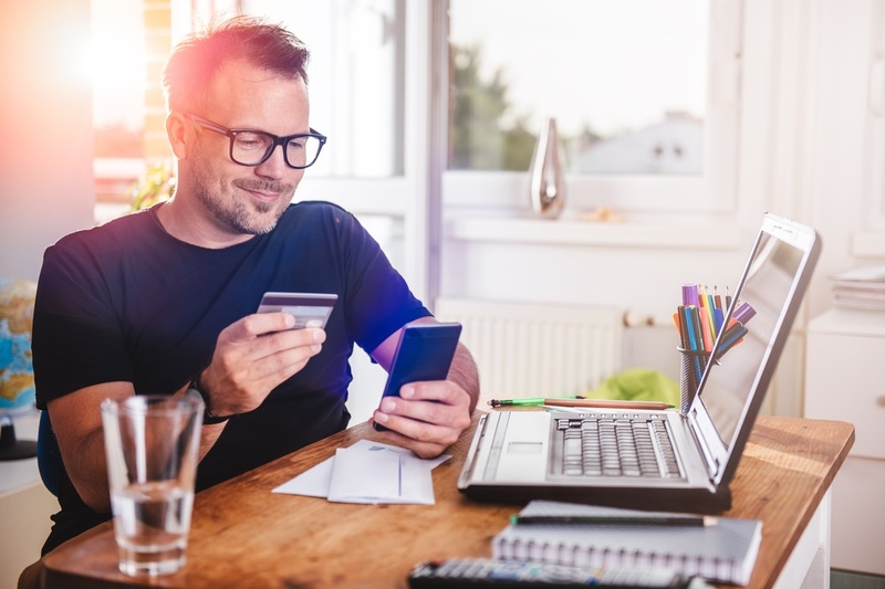 man checking card details on phone