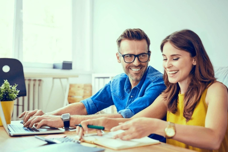 Couple at a table going through loan paperwork