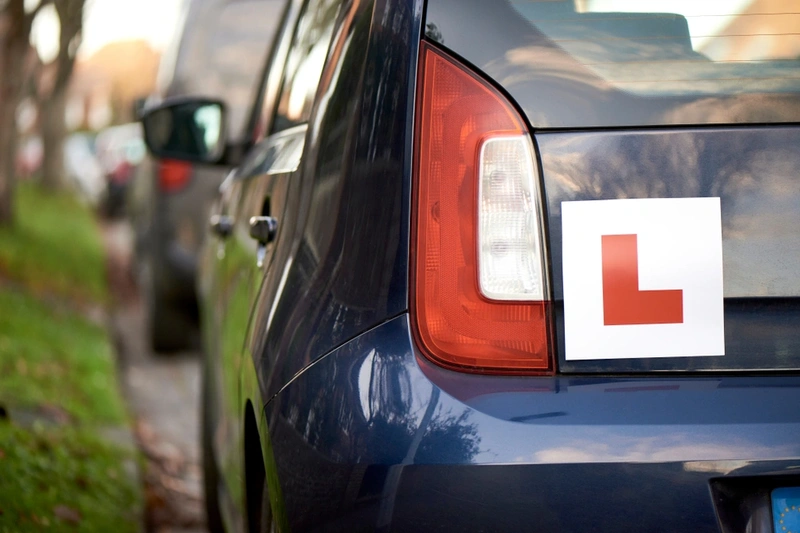 L plate sticker on the back of a car