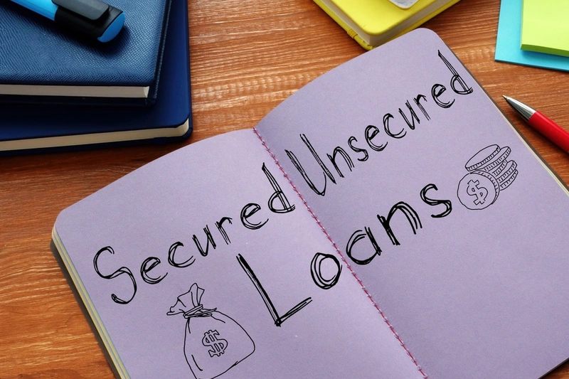 Secured and unsecured loans written in a notebook