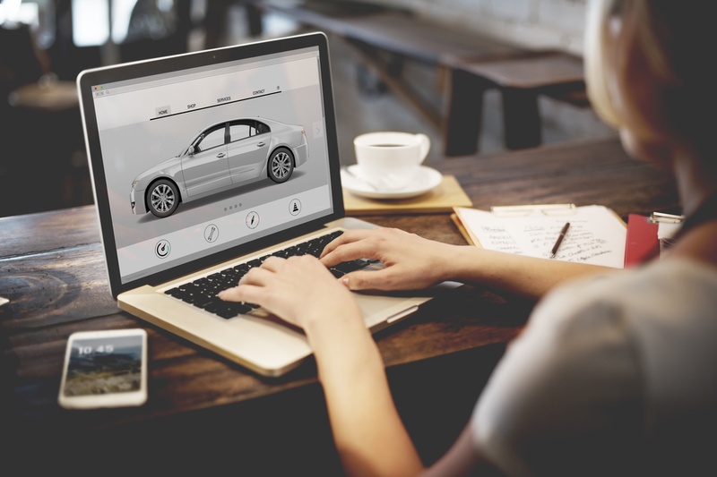 researching cars on laptop