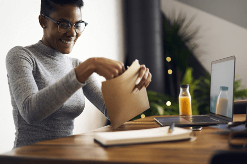 Woman opening a brown envelope