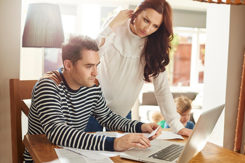 A man and a woman looking at a laptop