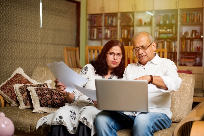 couple looking at laptop  in living room