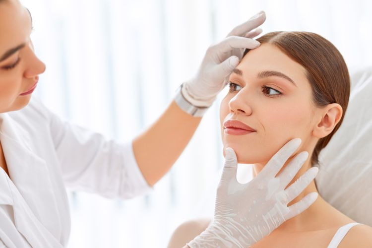 Young woman being examined by a dermatologist