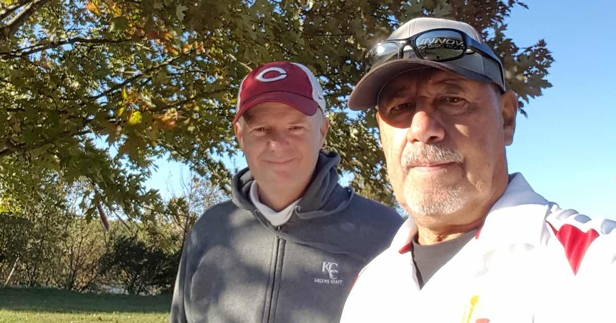 Two men in baseball caps outdoors