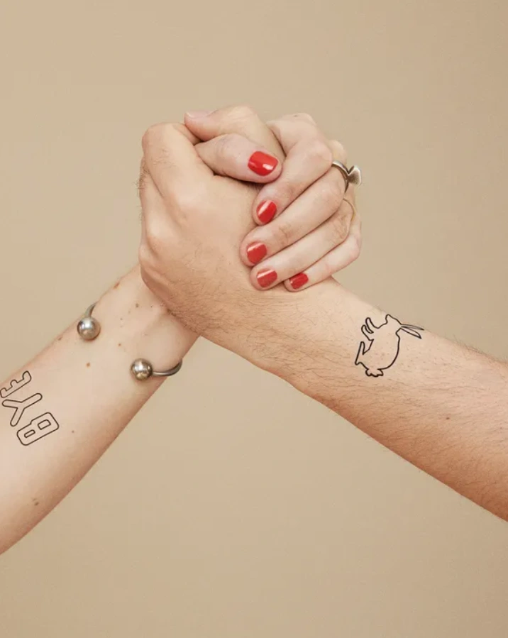 couple hands with temporary tattoos