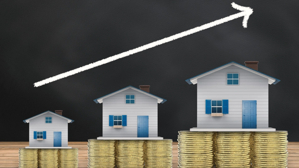 Real estate investment growth, house on gold coins, arrow pointing upwards