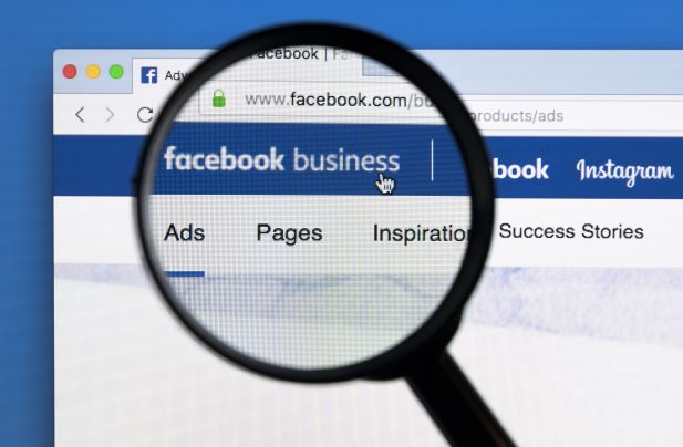 A magifying glass on the word facebook business