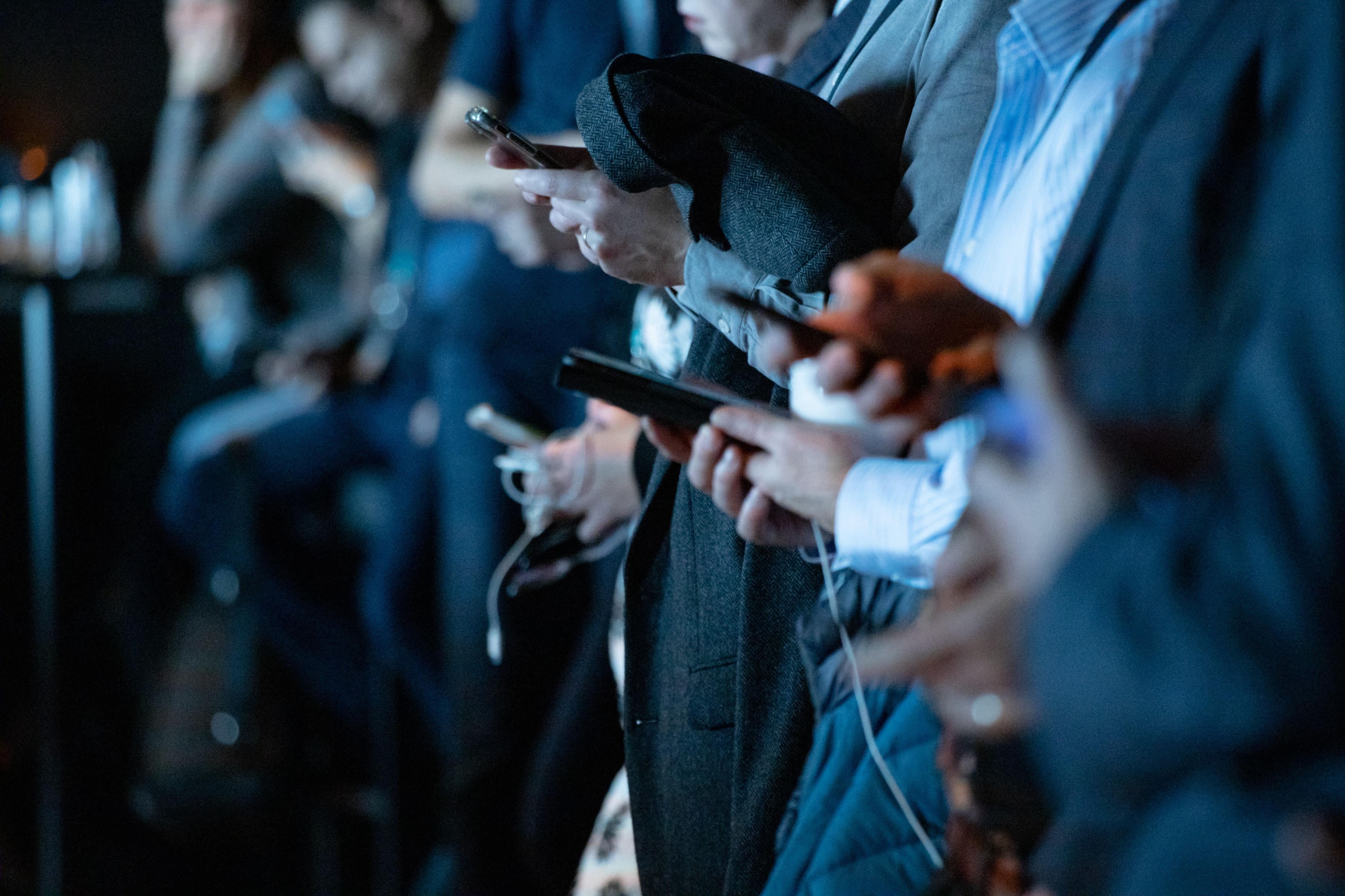 People in crowd checking phones