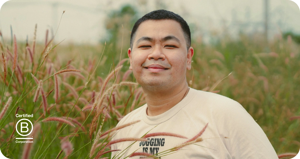 Smiling person standing in a field