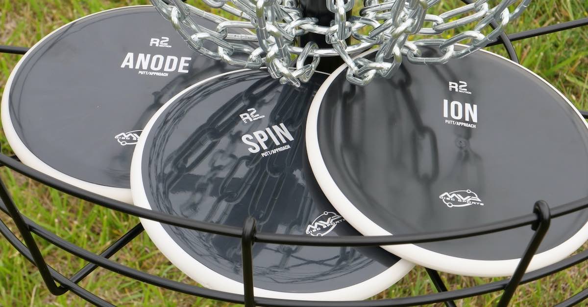 black discs in a disc golf basket