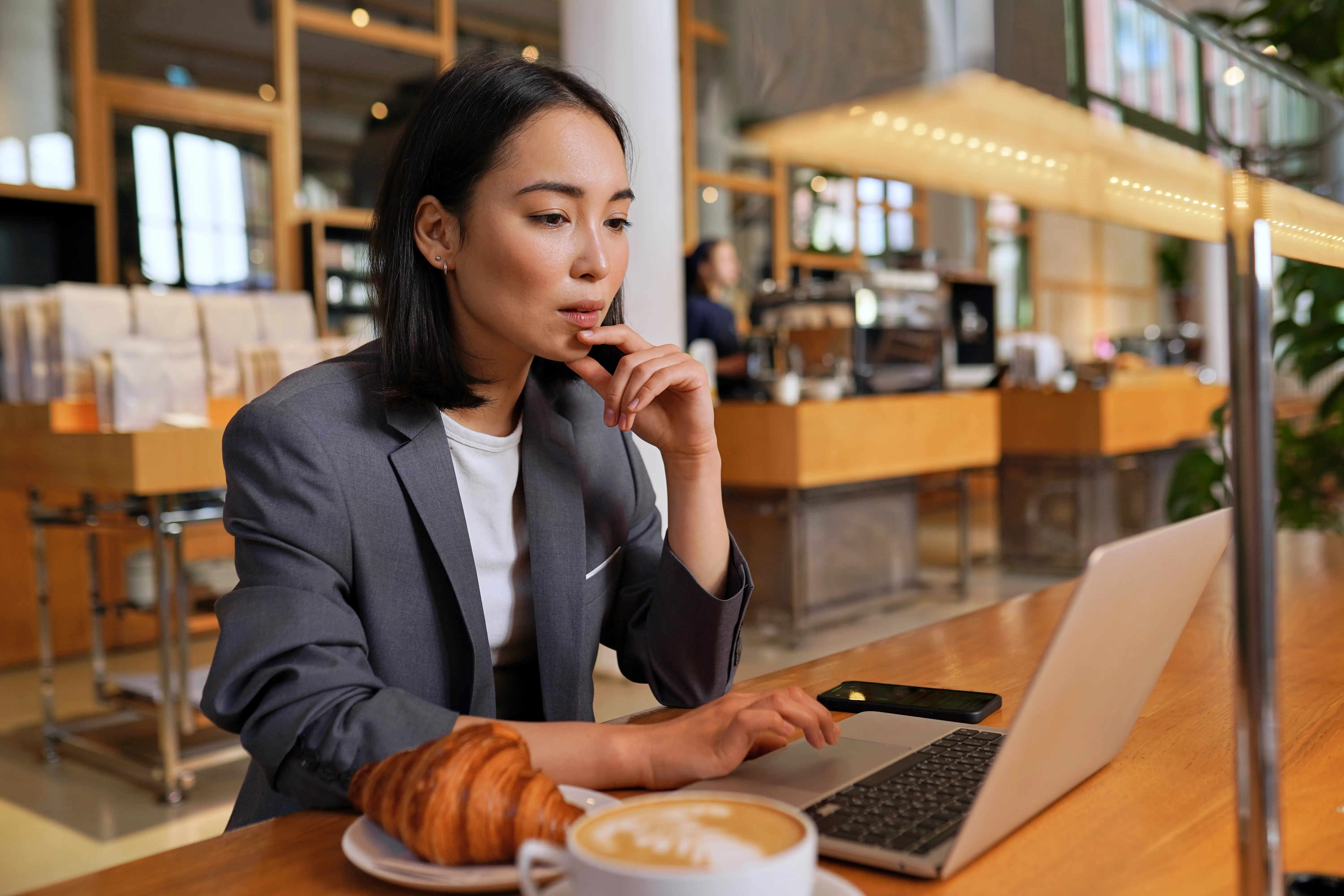 Independent contractor working on laptop in café to reduce isolation