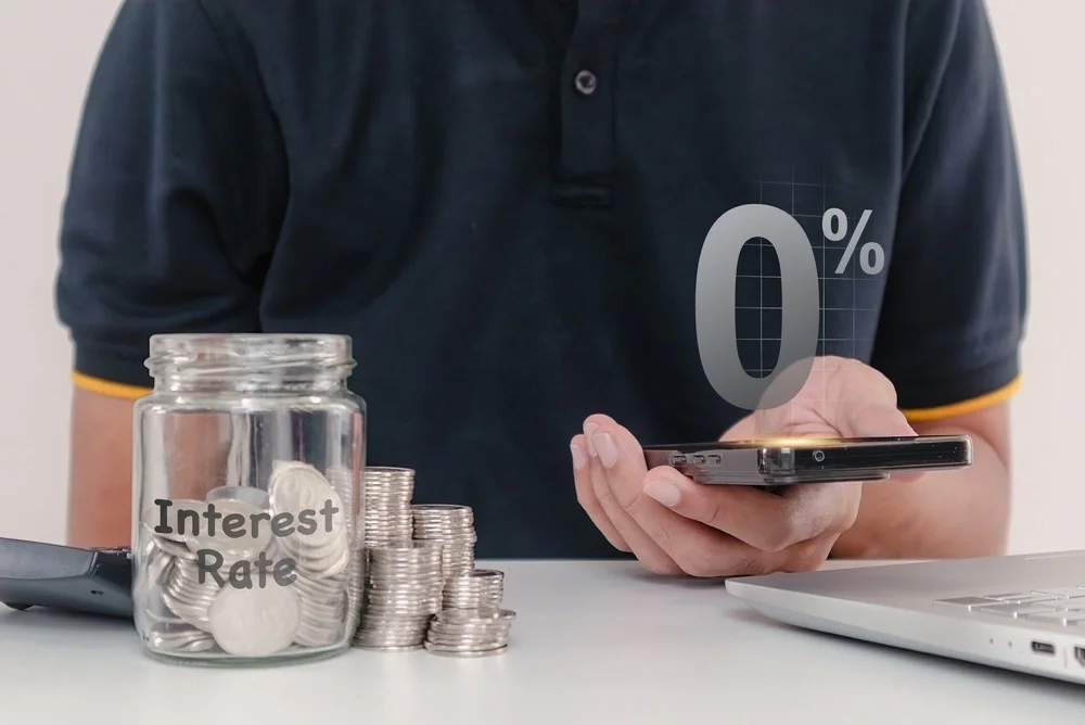 Man on calculator working out cost of a loan