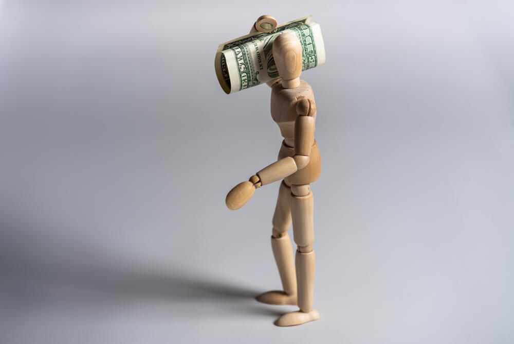 wooden man figure with money