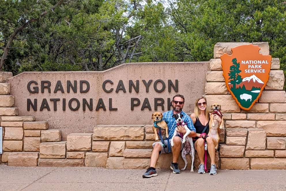 family infront of park sign